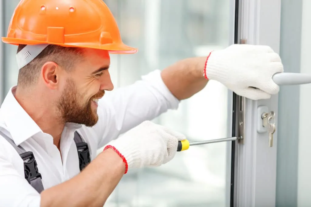 Smiling Locksmith Fixing Door